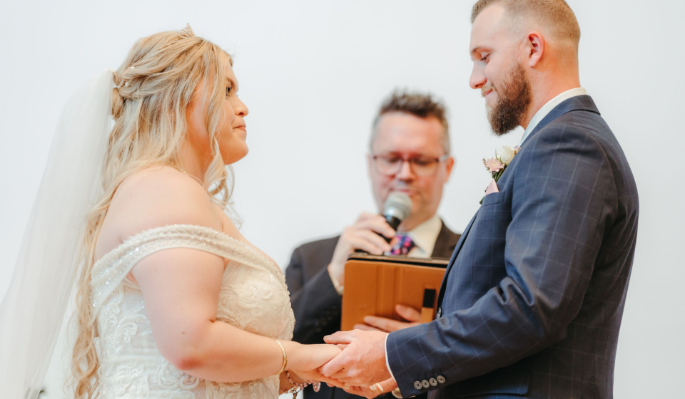 Couple standing in front of Mark Reynolds Celebrant during wedding ceremony
