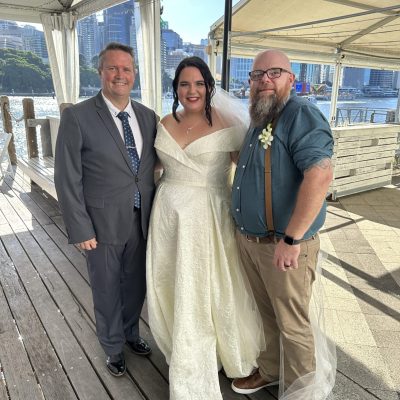 Mark Reynolds Celebrant with newly married couple on the deck at Riverlife Kangaroo Point
